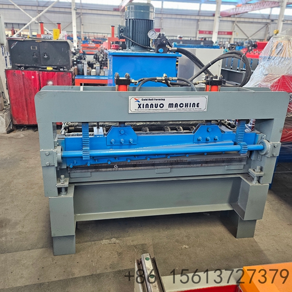 Blue industrial coil leveling and roll forming machine in a factory workshop with green floor markings.