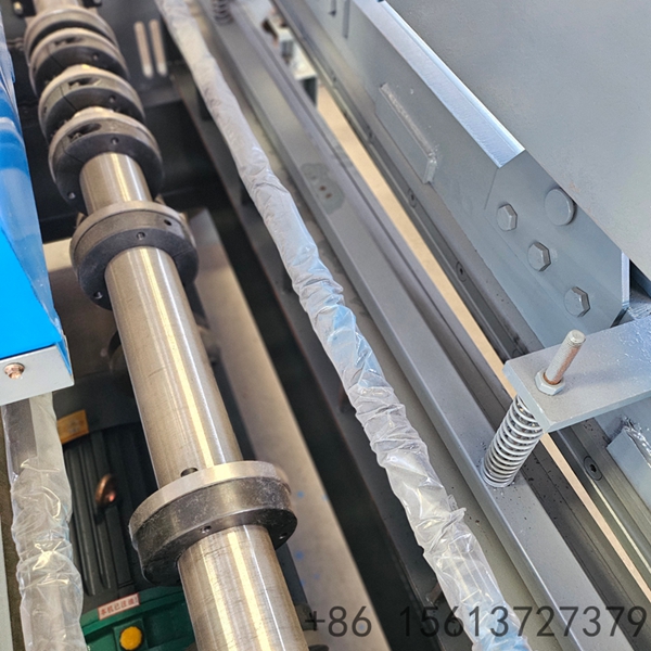 Interior view of a manufacturing plant displaying a large blue cut-to-length machine system.
