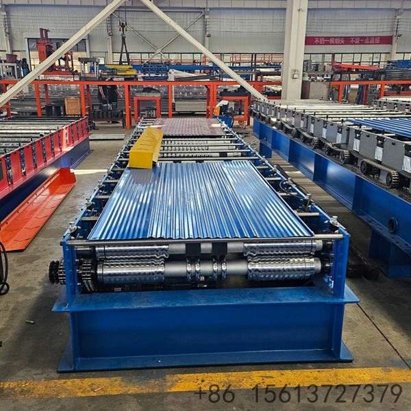 Industrial corrugated roof sheet roll forming machine processing steel coils in a factory.