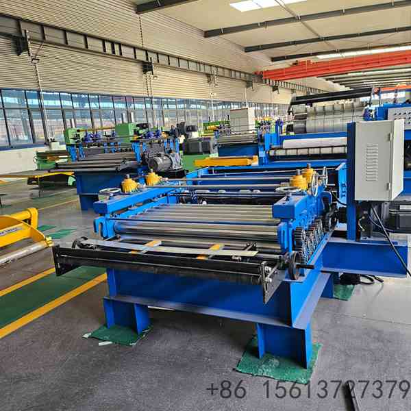 Industrial coil slitting and cutting line processing steel strips in a modern factory workshop.