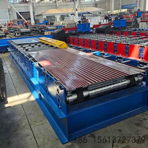 Factory floor scene with a yellow safety line separating the walkway from the corrugated sheet equipment.