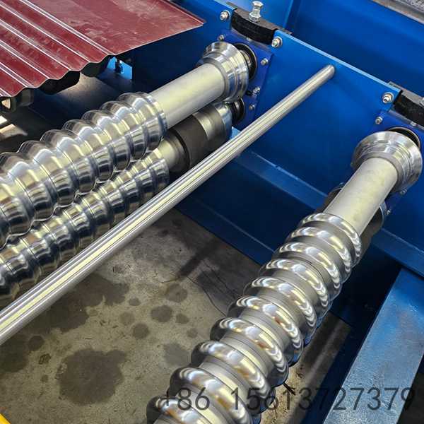 Automated corrugated iron sheet production line showing the decoiler and PLC control panel.