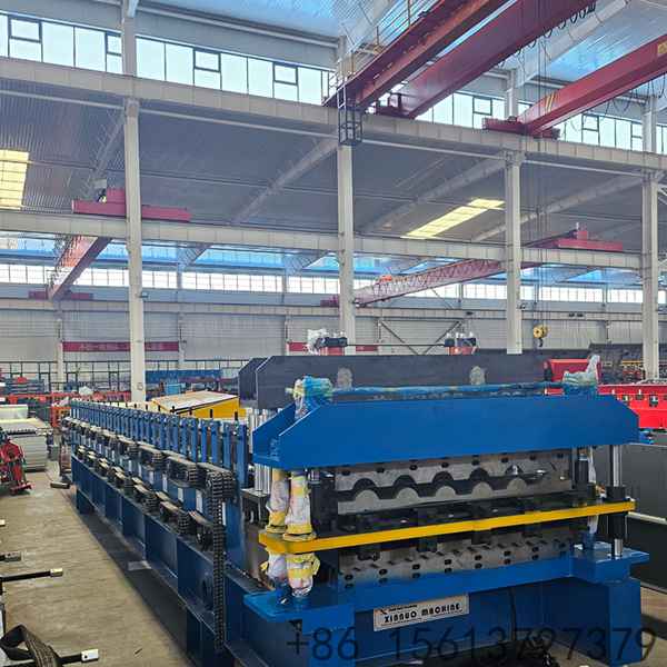 Factory floor scene with a yellow safety line separating the walkway from the tile forming equipment.