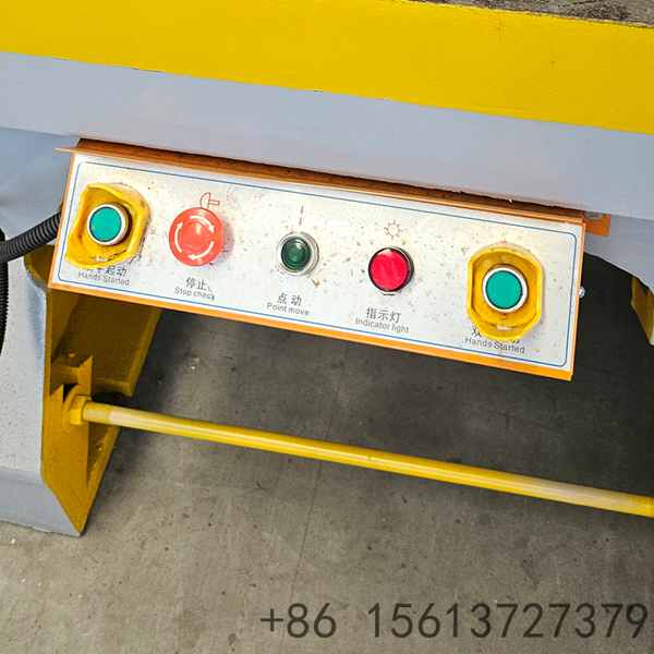 Close-up of the power press&rsquo;s worktable with yellow safety border and control panel for safe metal processing operations.
