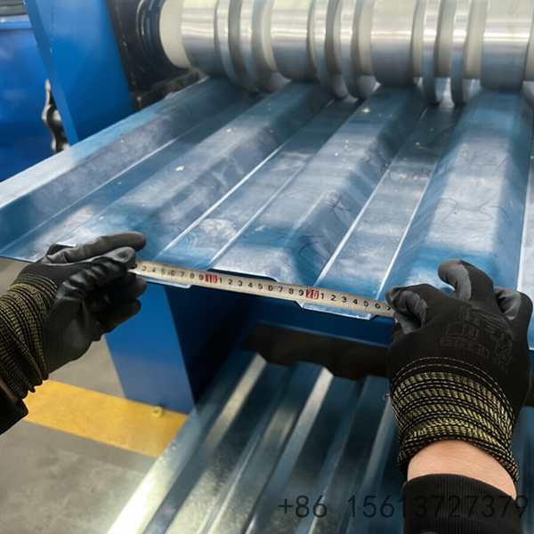 Industrial blue carriage board roll forming machine processing metal sheets in a factory workshop environment.