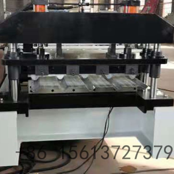 Industrial TR4 floor deck roll forming machine processing galvanized steel coils into structural metal decking sheets.