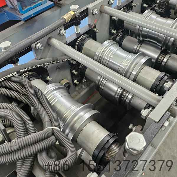 Precision roll forming station with multiple roller stations ensuring accurate shutter door profile shaping