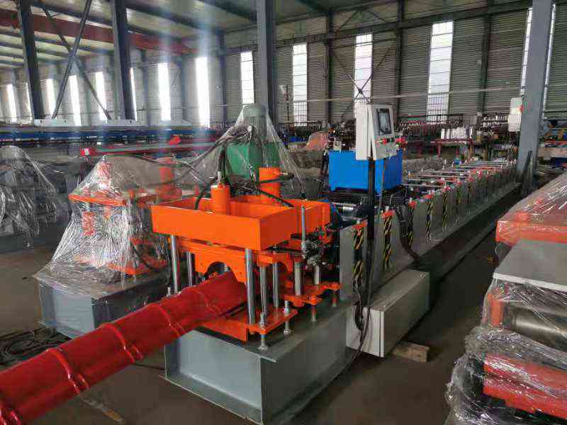 Precision roll forming station with multiple roller stations ensuring accurate ridge cap profile shaping