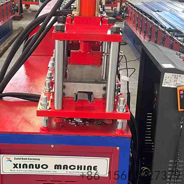 Precision roll forming station with multiple roller stations ensuring accurate shutter door profile shaping