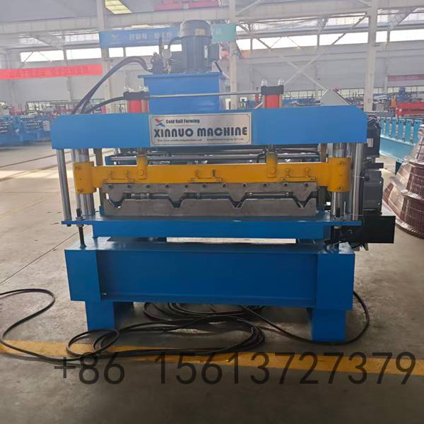 Close-up view of the roller station on a camber curving machine showing the gradual bending process of galvanized steel material.