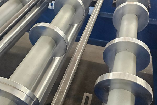 Reinforced steel base frame providing exceptional stability during continuous sheet panel forming operation