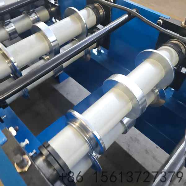 Forming stations of the wide exterior wall cladding machine folding a wide metal cladding panel for a large facade